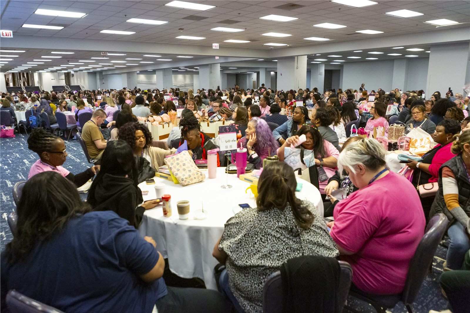 Large professional conference general session with attendees seated at round tables