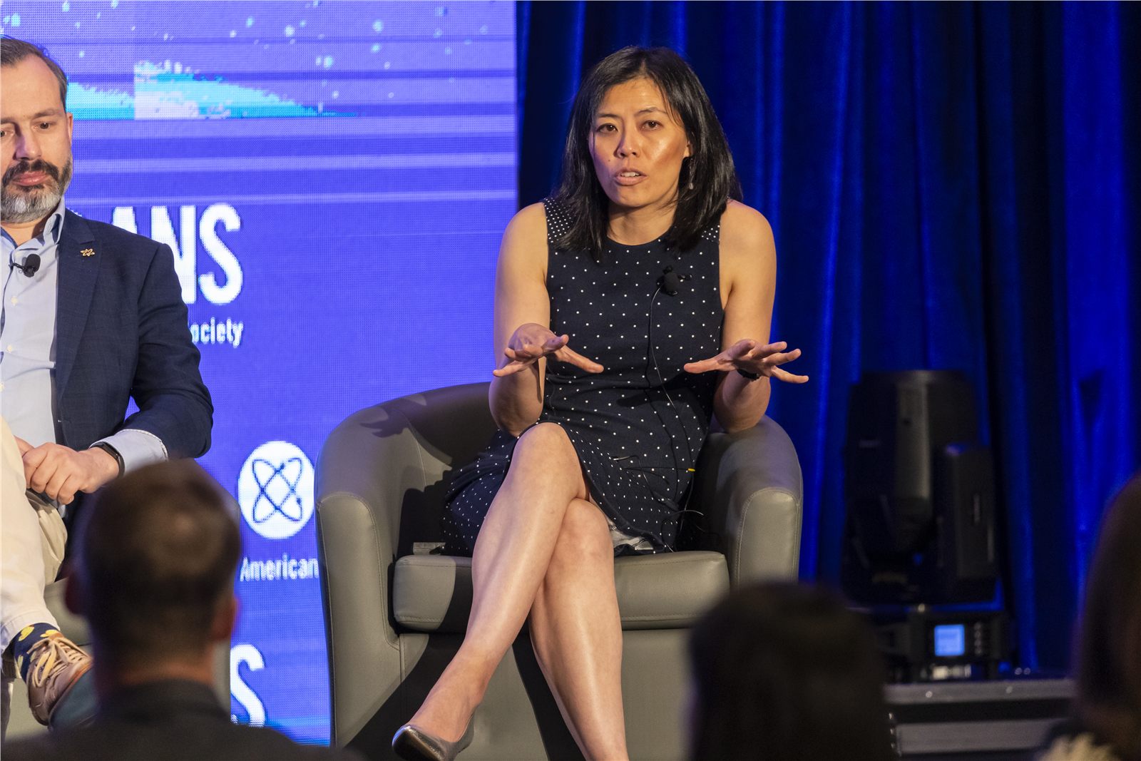 Panelist speaking during an on-stage conference discussion
