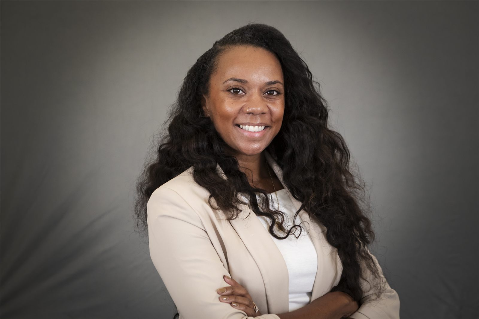 Corporate headshot of a woman wearing a cream blazer