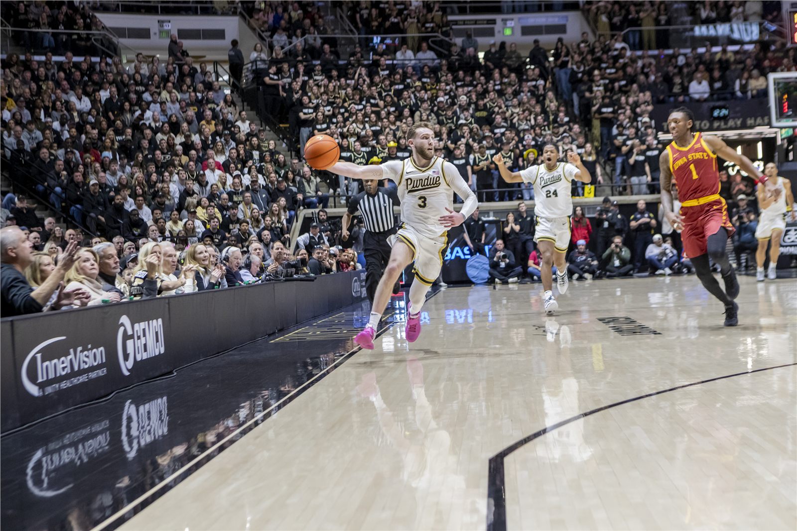 Basketball player making a fast sideline pass during game action