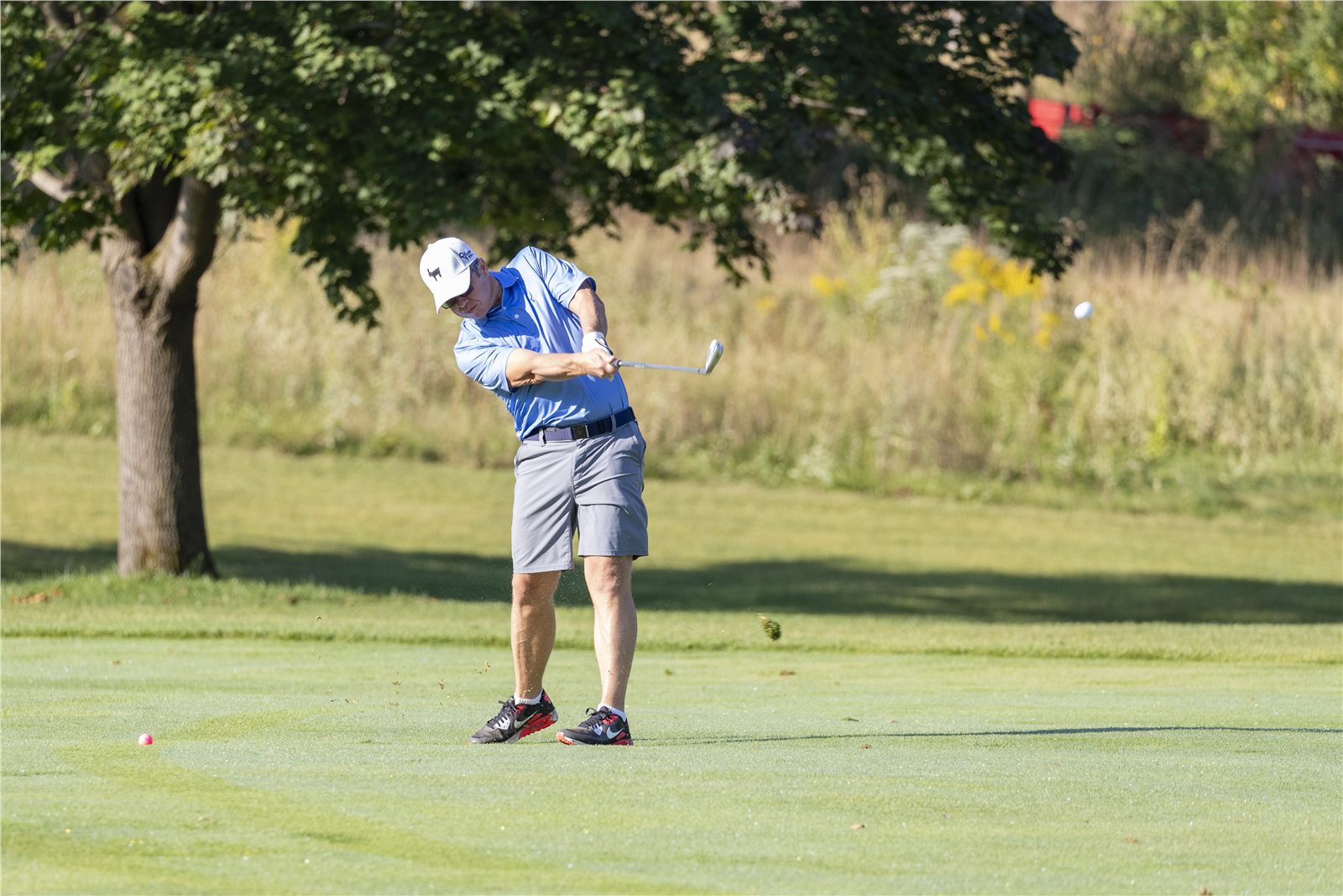 Golfer driving from the fairway during a corporate golf outing